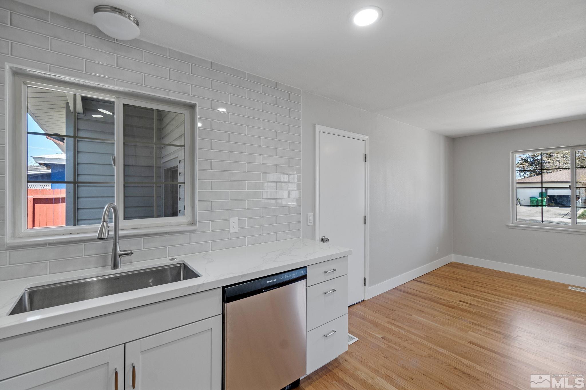 1685 Clemson Road Reno, NV 89502 - Photo 7 of 32 a kitchen with a sink and wooden floor