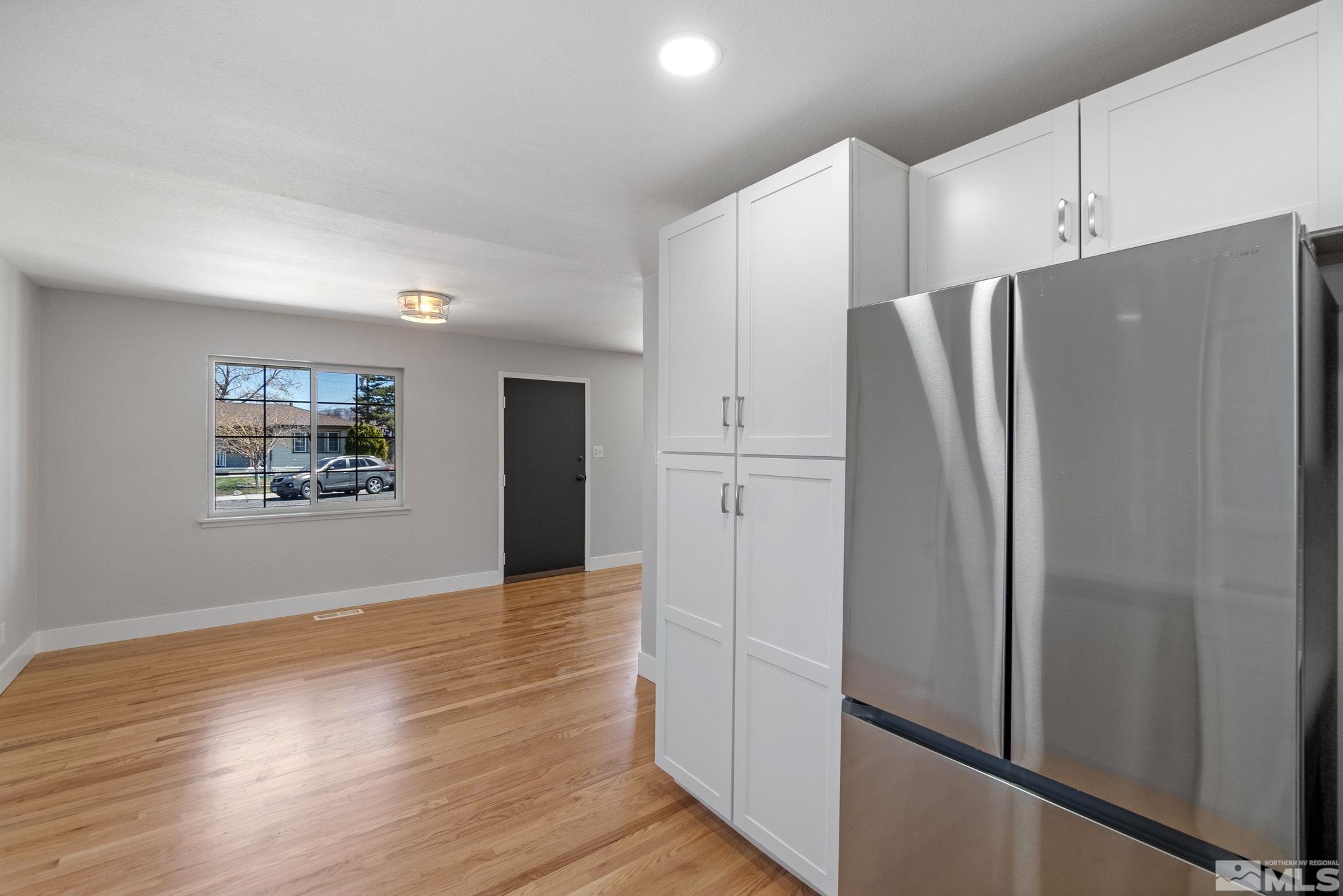 1685 Clemson Road Reno, NV 89502 - Photo 8 of 32 a view of a kitchen with refrigerator and wooden floor