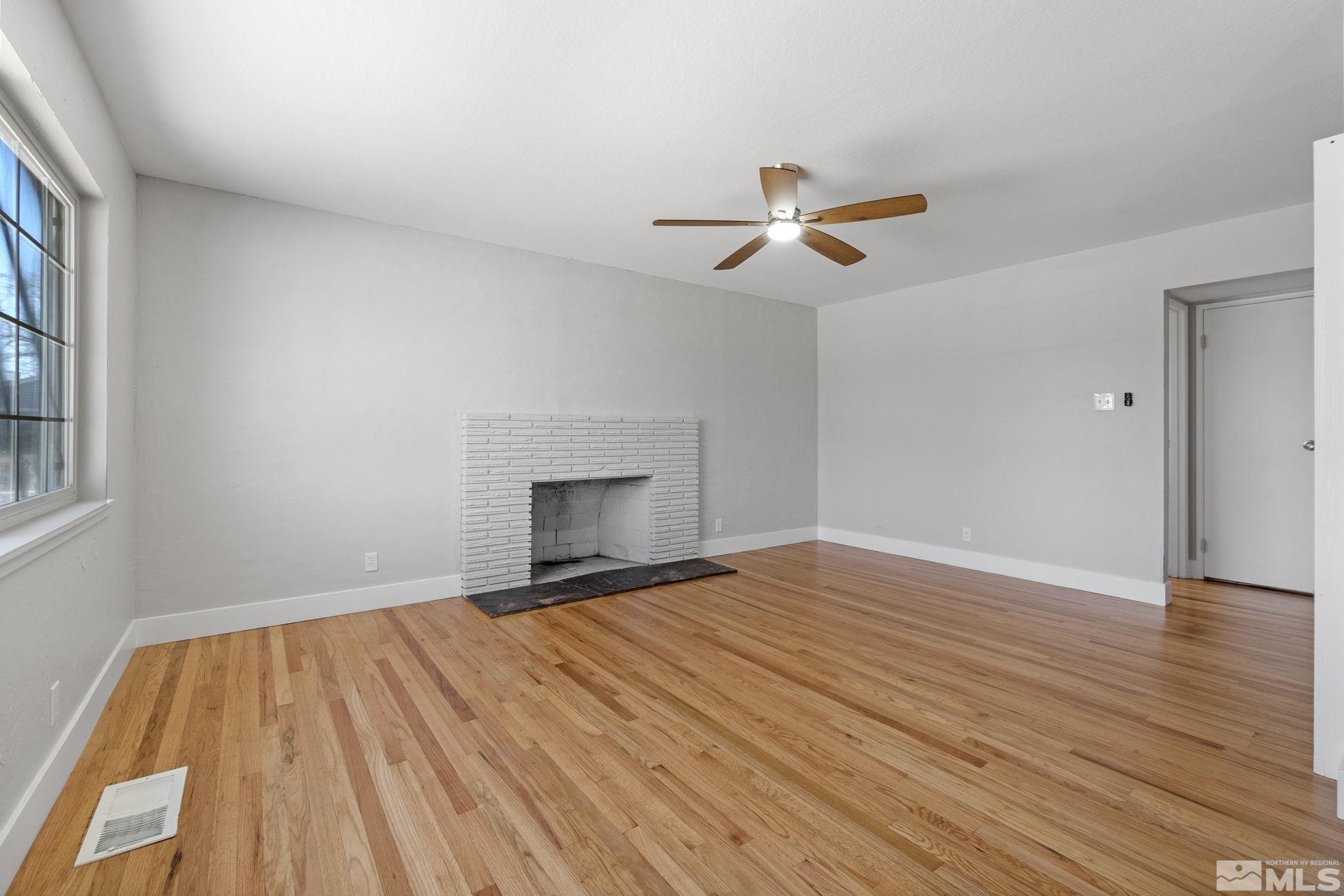 1685 Clemson Road Reno, NV 89502 - Photo 10 of 32 a view of empty room with wooden floor and fan