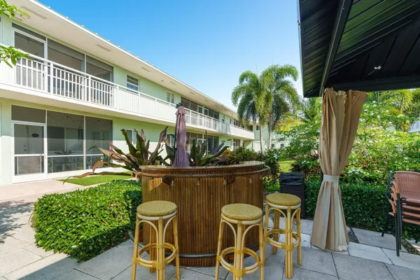 a view of a house with a backyard porch and sitting area