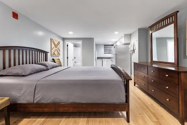 a bedroom with a large bed and a dresser