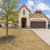 a front view of a house with yard and garage
