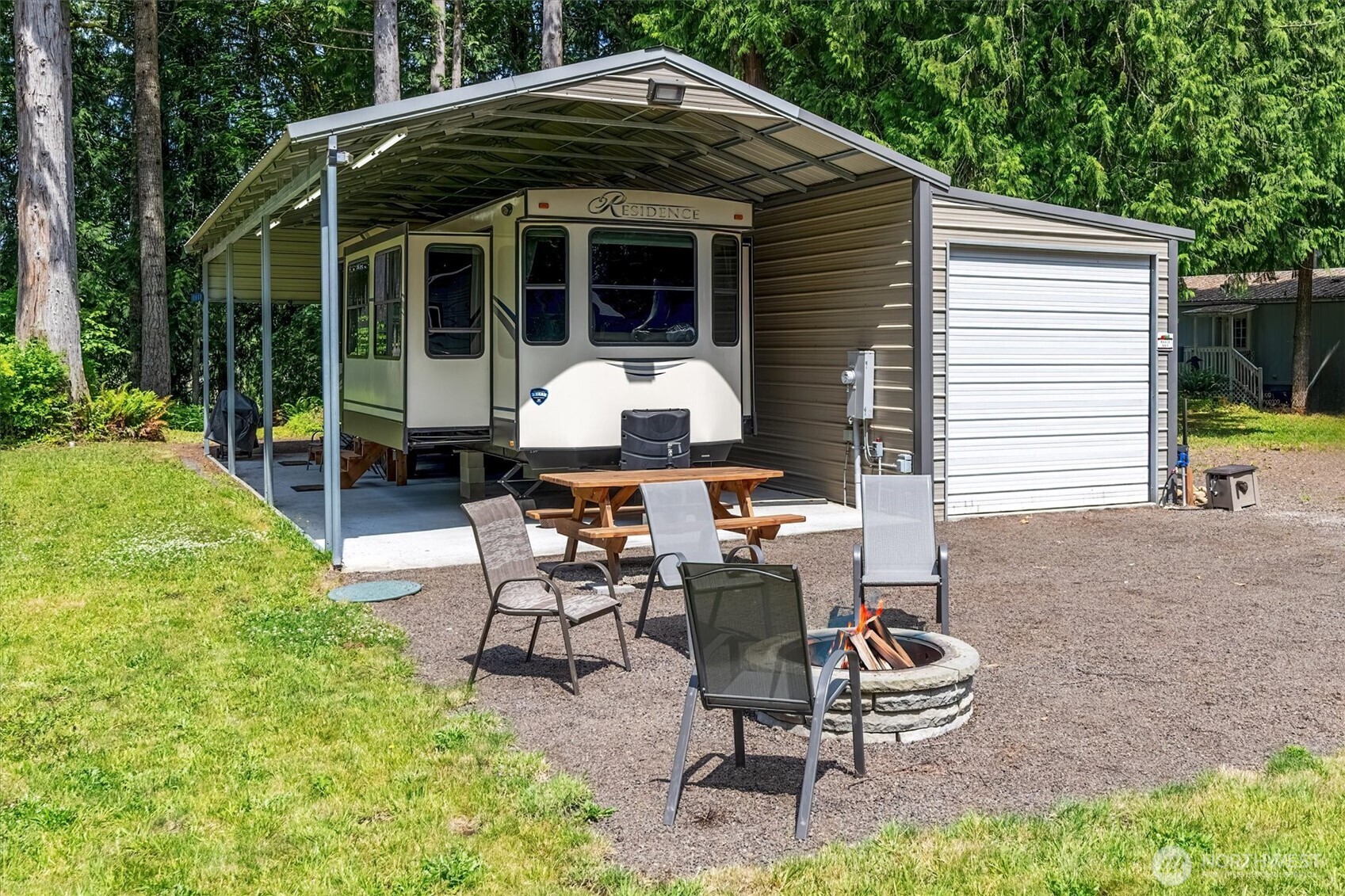 a view of a patio with table and chairs with wooden fence and plants