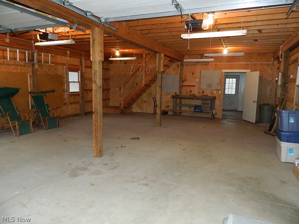 9284 Mayfield Road Chesterland, OH 44026 - Photo 25 of 33 First Level of 40x44' Outbuilding - There Are Two Garage Door Openers, Concrete Flooring, and a Drain in the Front of the Outbuilding.