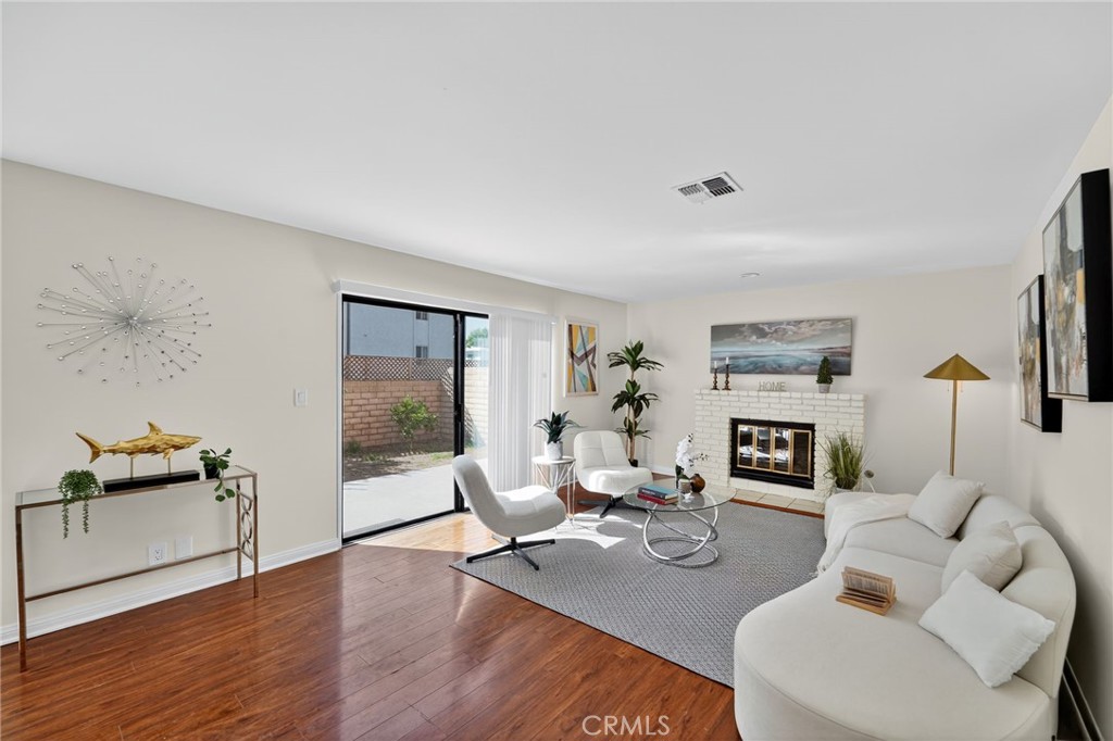 20254 Stagg Street Winnetka, CA 91306 - Photo 11 of 27 a living room with furniture and a fireplace