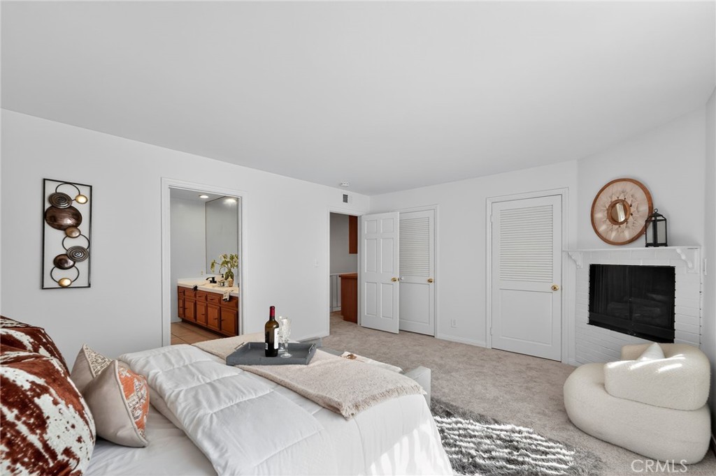 20254 Stagg Street Winnetka, CA 91306 - Photo 18 of 27 a bedroom with a bed and a chair