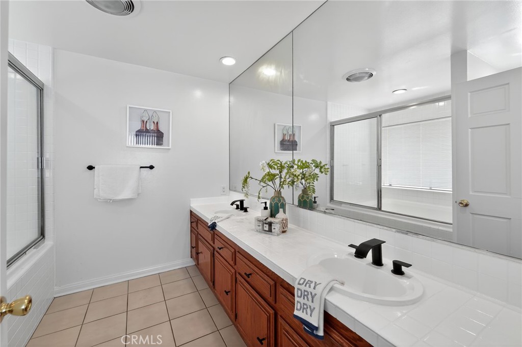 20254 Stagg Street Winnetka, CA 91306 - Photo 19 of 27 a bathroom with a sink a toilet and a mirror