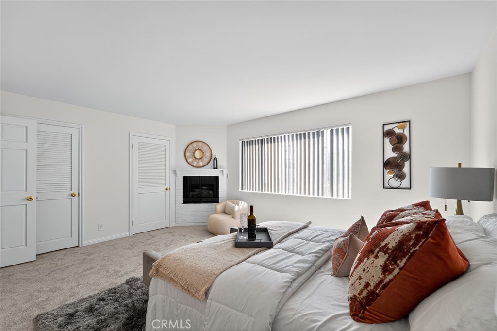 20254 Stagg Street Winnetka, CA 91306 - Photo 20 of 27 a bedroom with a bed and a large window