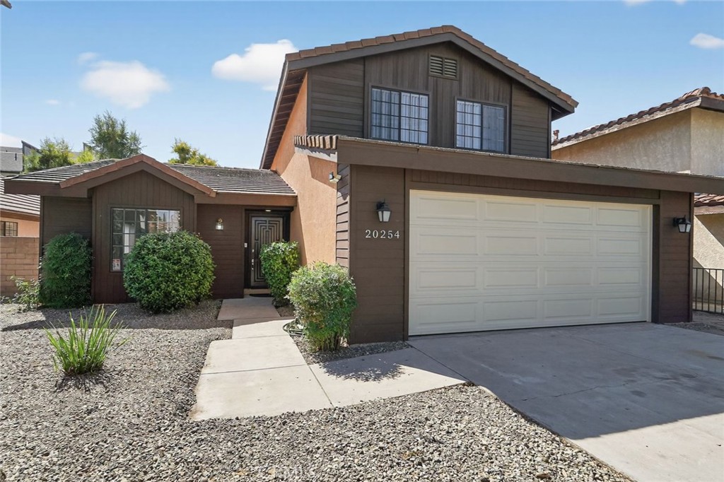20254 Stagg Street Winnetka, CA 91306 - Photo 2 of 27 a front view of a house with garden