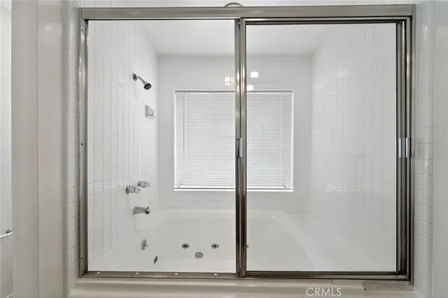 a bathroom with a glass shower door