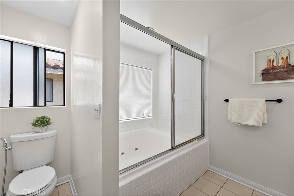 20254 Stagg Street Winnetka, CA 91306 - Photo 23 of 27 a bathroom with a toilet a sink and shower