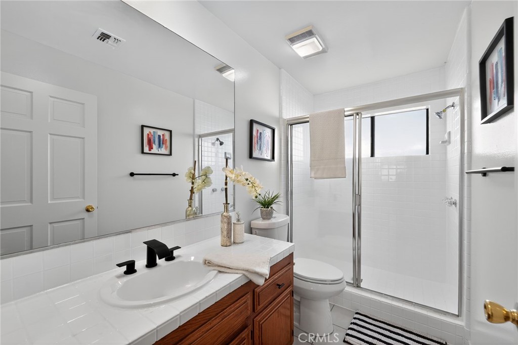 20254 Stagg Street Winnetka, CA 91306 - Photo 26 of 27 a bathroom with a sink toilet and shower