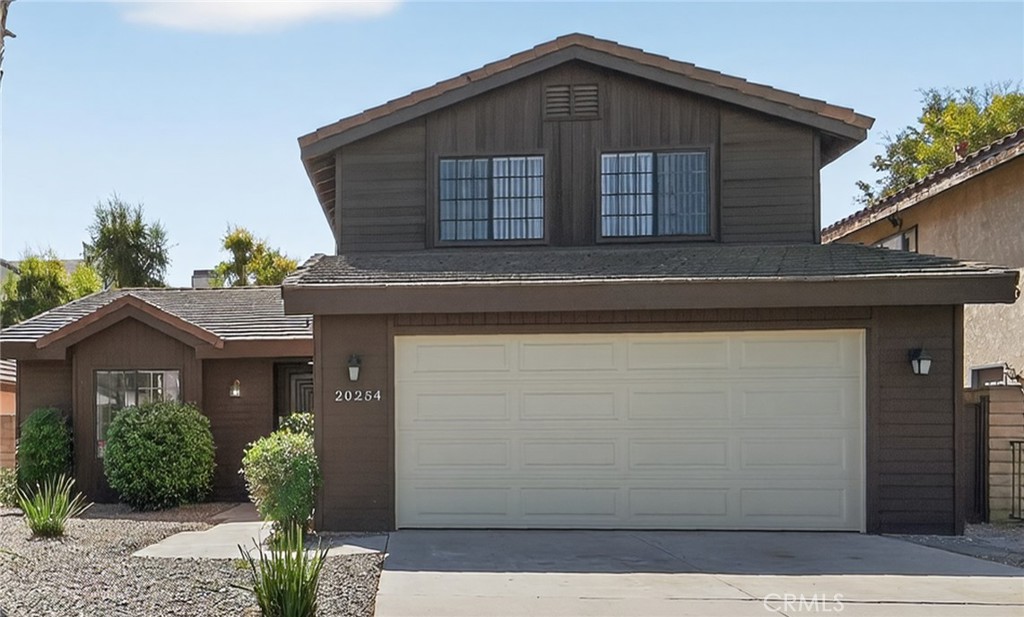 20254 Stagg Street Winnetka, CA 91306 - Photo 3 of 27 a front view of a house with a yard