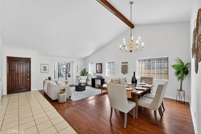 a living room with fireplace furniture and a chandelier