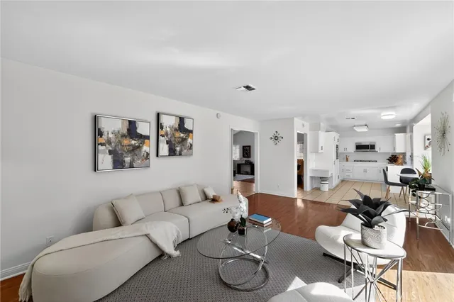 a living room with furniture kitchen view and a table