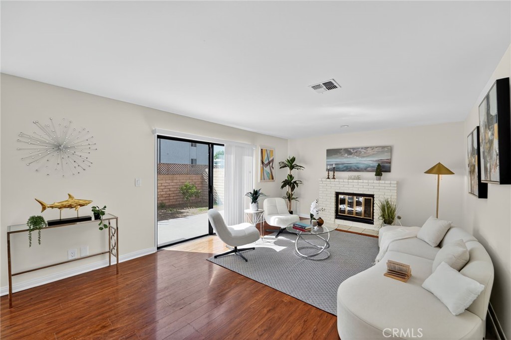 20254 Stagg Street Winnetka, CA 91306 - Photo 9 of 27 a living room with furniture and a fireplace