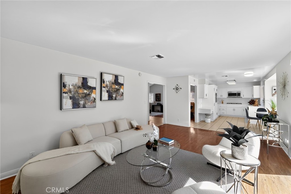 20254 Stagg Street Winnetka, CA 91306 - Photo 10 of 27 a living room with furniture kitchen view and a table