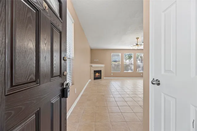 a view of a hallway with wooden floor and a living room