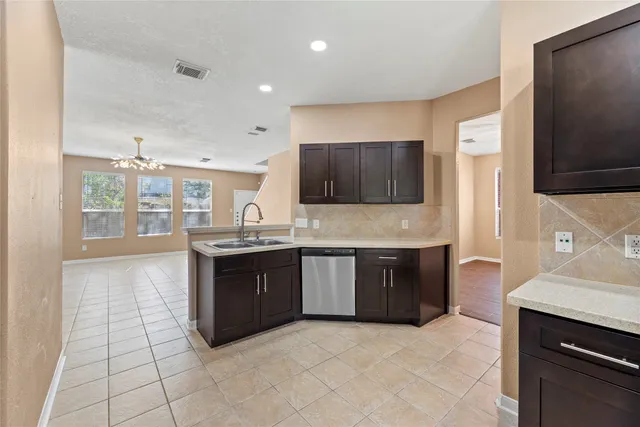 a large kitchen with stainless steel appliances granite countertop a stove a sink and a microwave