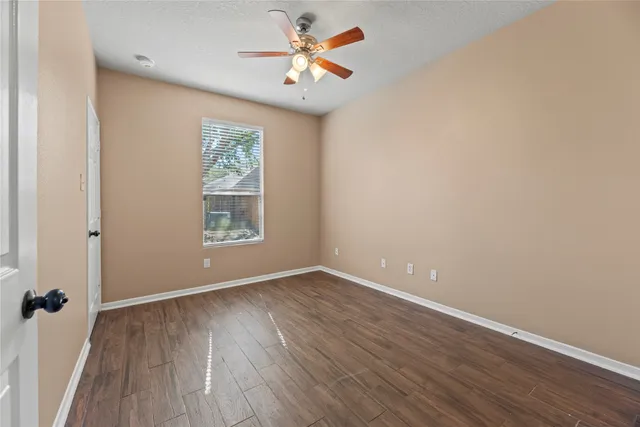 wooden floor in an empty room with a window