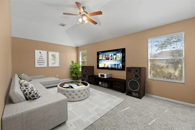 an empty room with a ceiling fan and window
