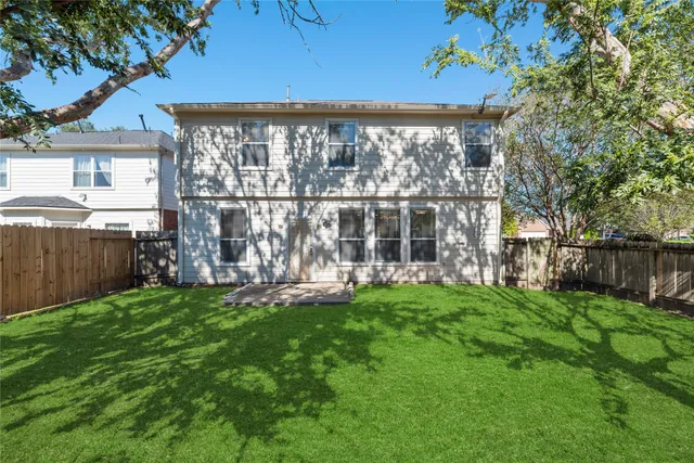 a view of a house with a yard and sitting area