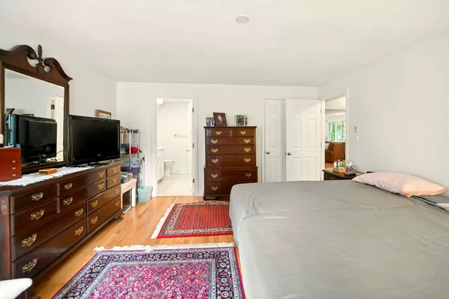 a bedroom with a bed and flat screen tv