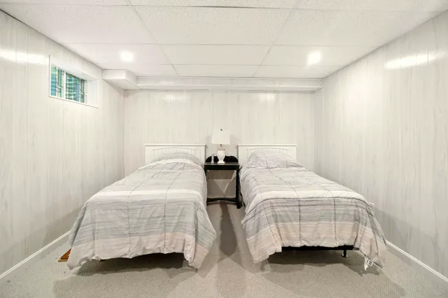 a bedroom with two beds and painted walls