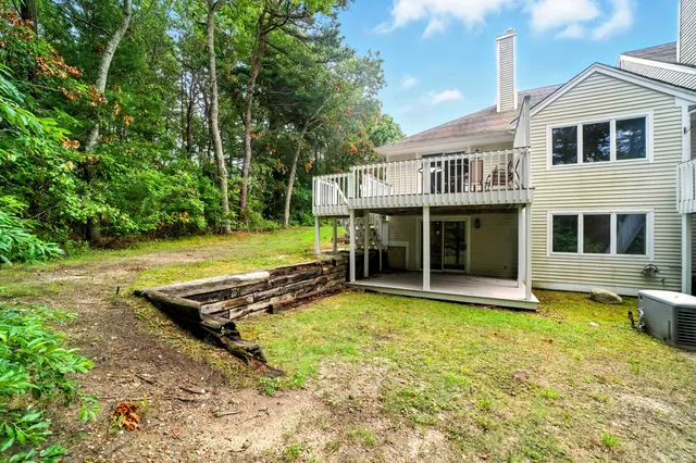 a view of an house with backyard space and balcony