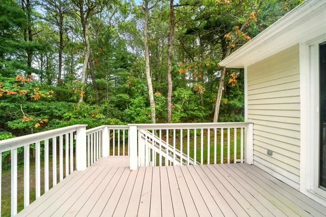 a view of balcony with wooden floor and fence