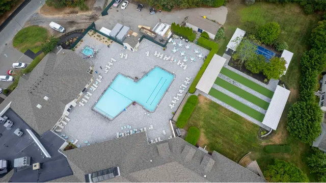 an aerial view of a house with a yard and lake view