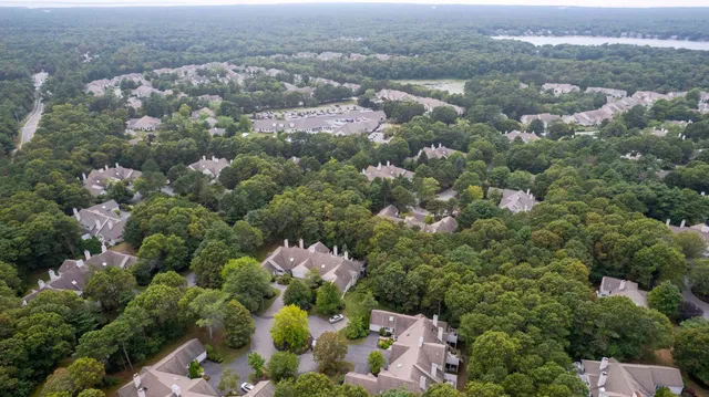 an aerial view of a houses with a yard