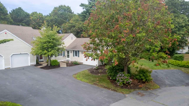 a aerial view of a house with a yard and sitting area