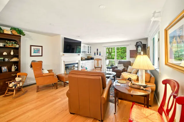a living room with furniture fireplace and a flat screen tv