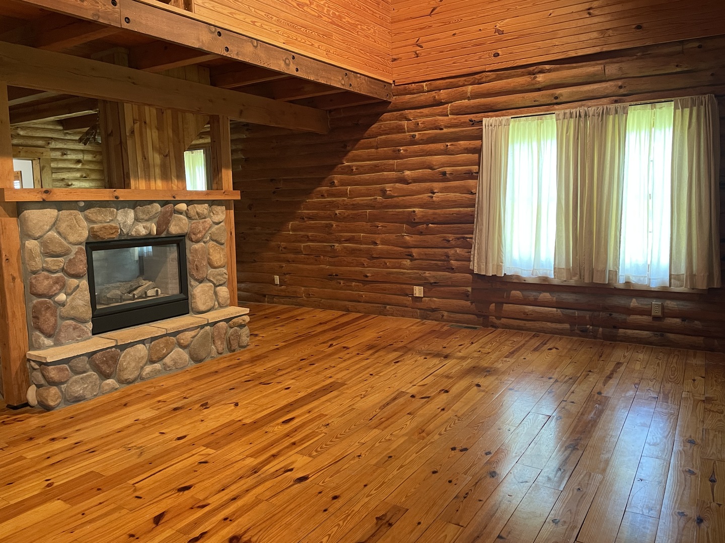 9826 Birkbeck Road Clinton, IL 61727 - Photo 7 of 32 a view of a room with wooden floor and a fireplace