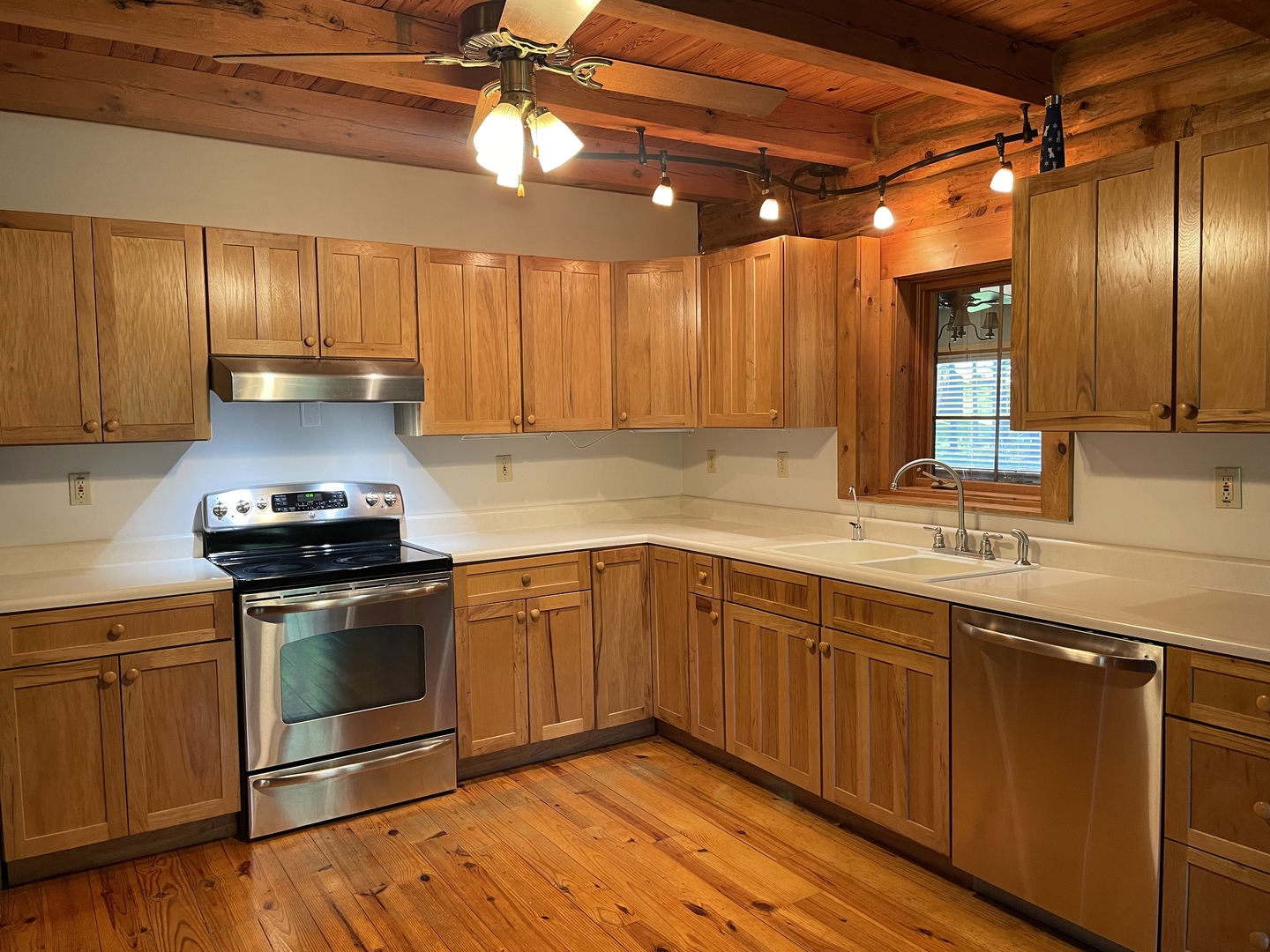 9826 Birkbeck Road Clinton, IL 61727 - Photo 10 of 32 a kitchen with stainless steel appliances granite countertop a stove a sink and a microwave