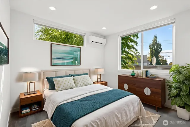 a bedroom with a bed and a large window