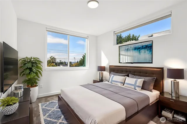 a bedroom with a bed and a potted plant