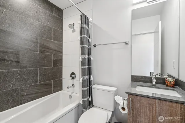 a bathroom with a sink toilet vanity and shower
