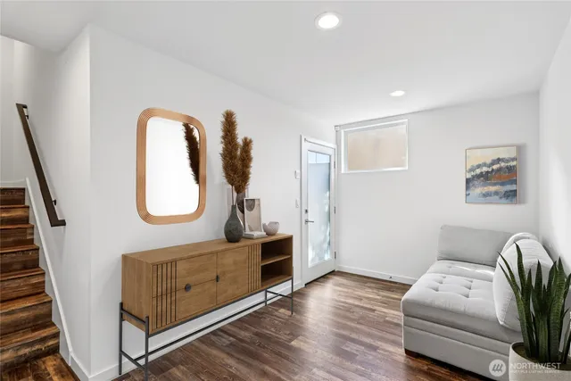 a living room with furniture and a wooden floor