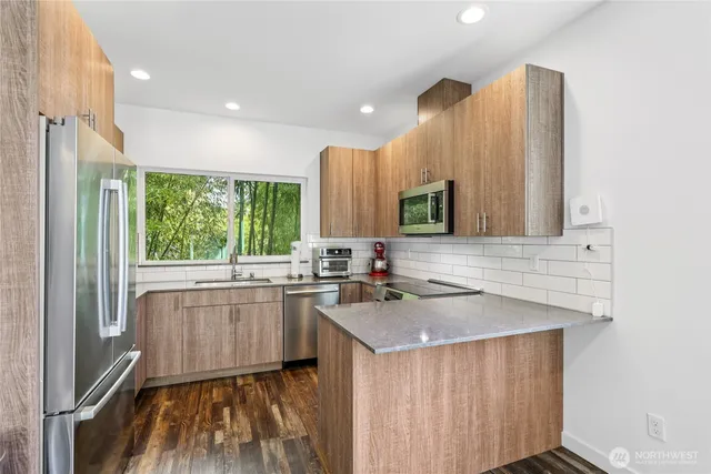 a kitchen with a sink stove and microwave