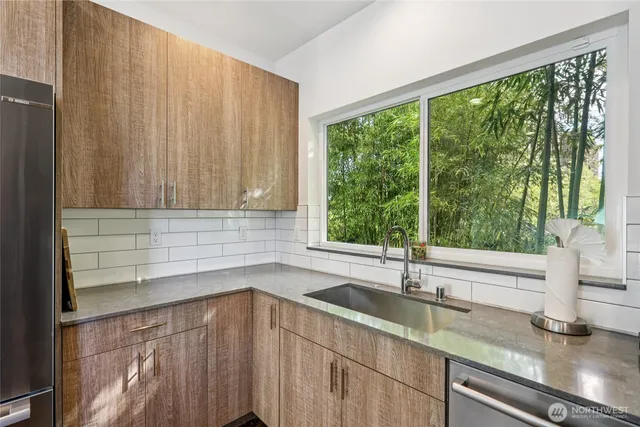 a kitchen with a sink and large window