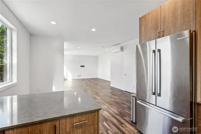 a kitchen with stainless steel appliances granite countertop a refrigerator and a sink