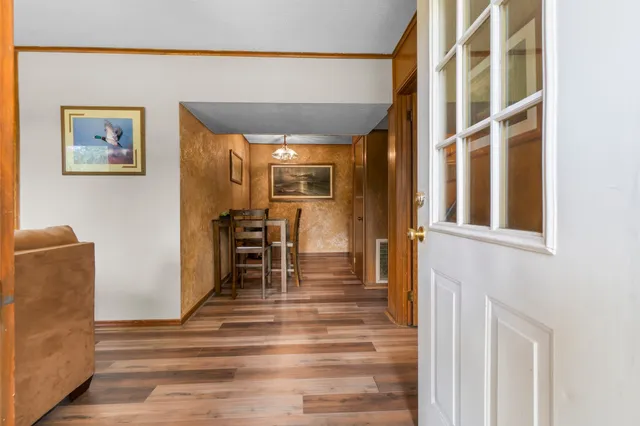 a living room with furniture a large window and a flat screen tv