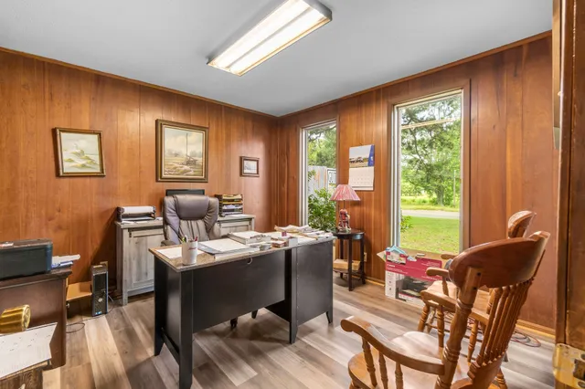 a view of a dining room with furniture and wooden floor