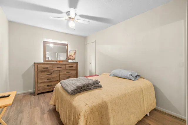 a living room with furniture a ceiling fan and a flat screen tv