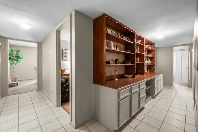 a kitchen with a table chairs and a refrigerator