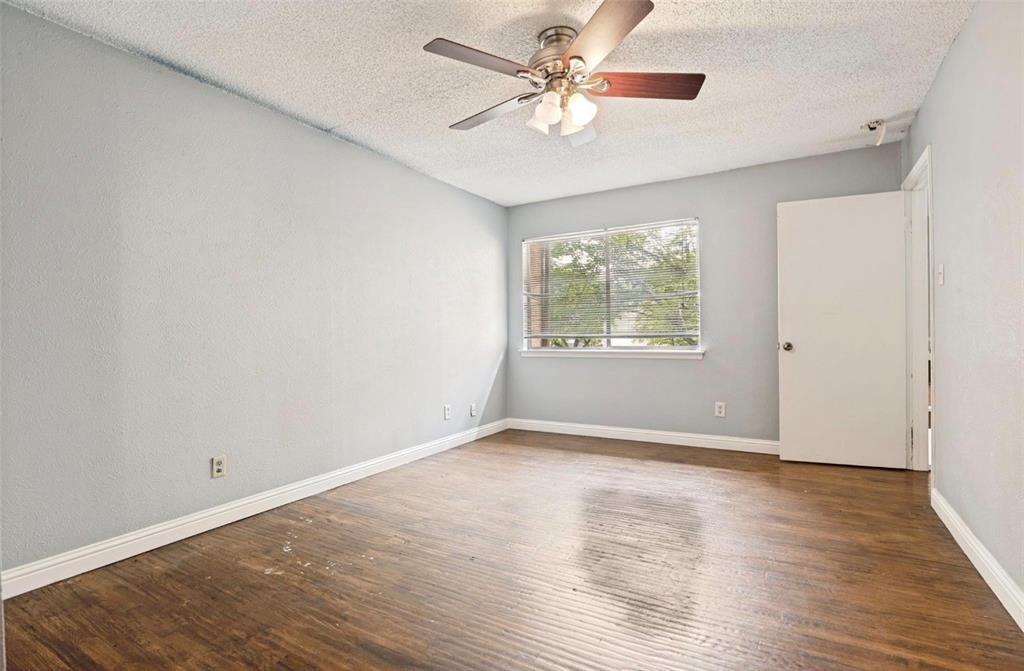 5808 Harvest Hill Road Dallas, TX 75230 - Photo 12 of 18 Spacious room featuring wood-finish flooring, a ceiling fan with light fixture, and a window with blinds