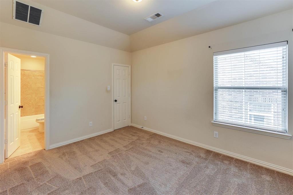 419 Rio Grande Drive Irving, TX 75039 - Photo 26 of 29 Carpeted room featuring a single window with blinds, a white paneled door, and neutral wall paint