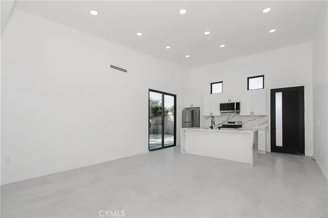 a kitchen with a refrigerator stove and sink